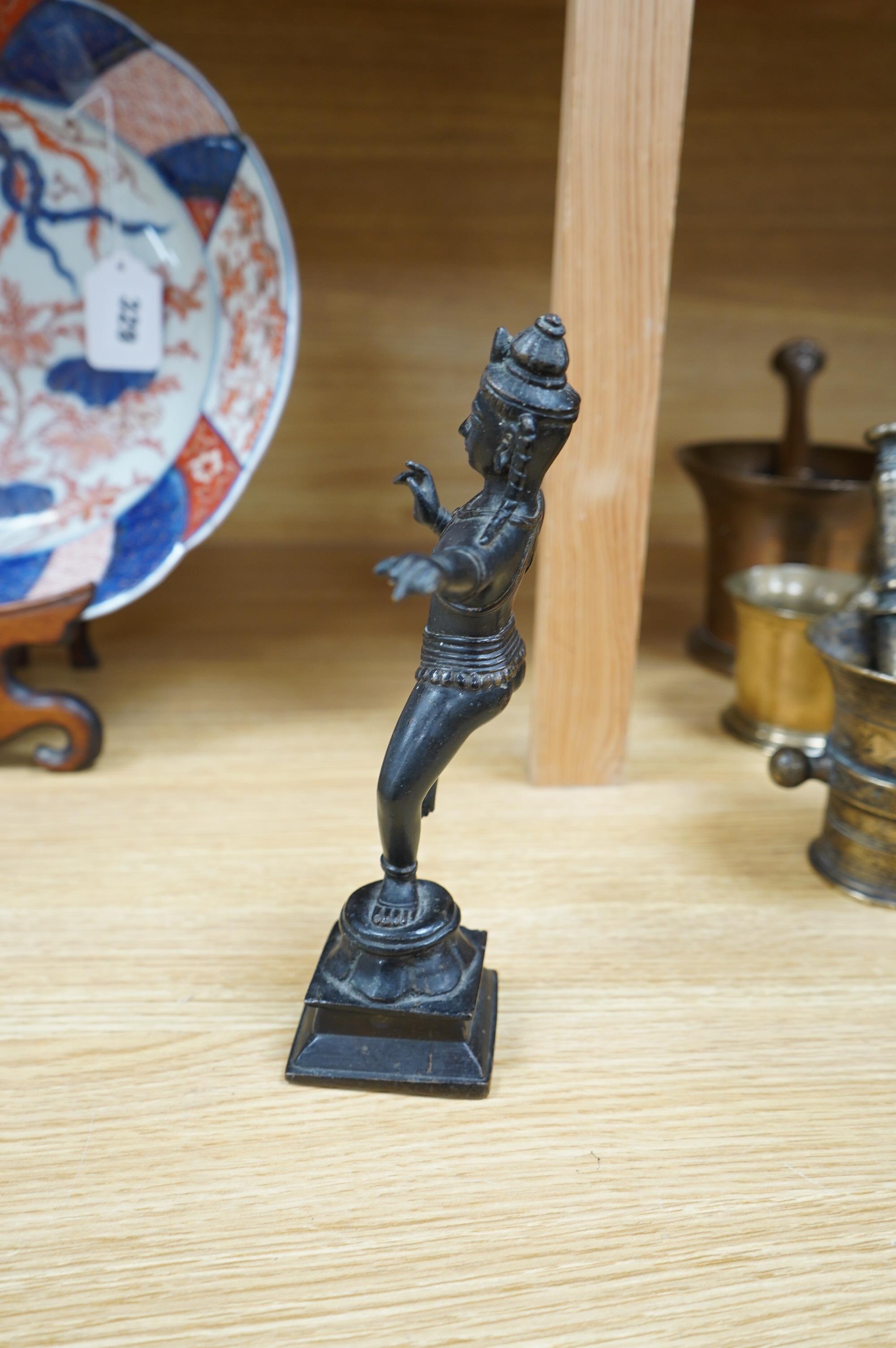 A Tibetan bronze dancing deity, 23cm high. Condition - fair